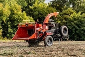 New Brush Chipper waiting in field,New Morbark working in a field